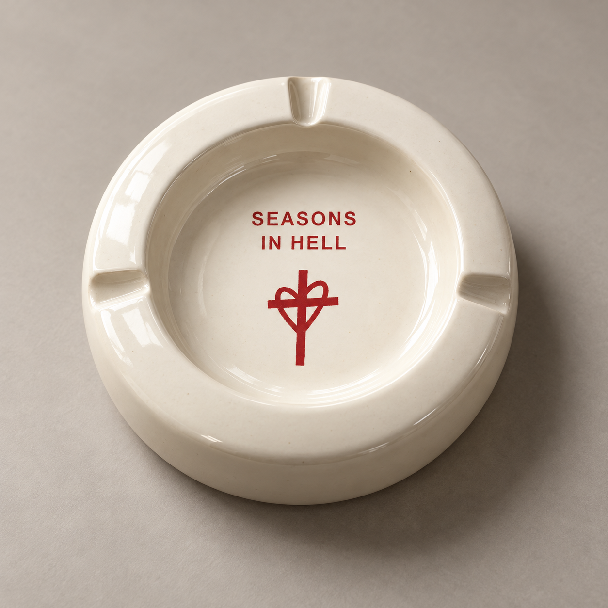 White Ceramic Ashtray with Seasons In Hell lettering and heart and cross