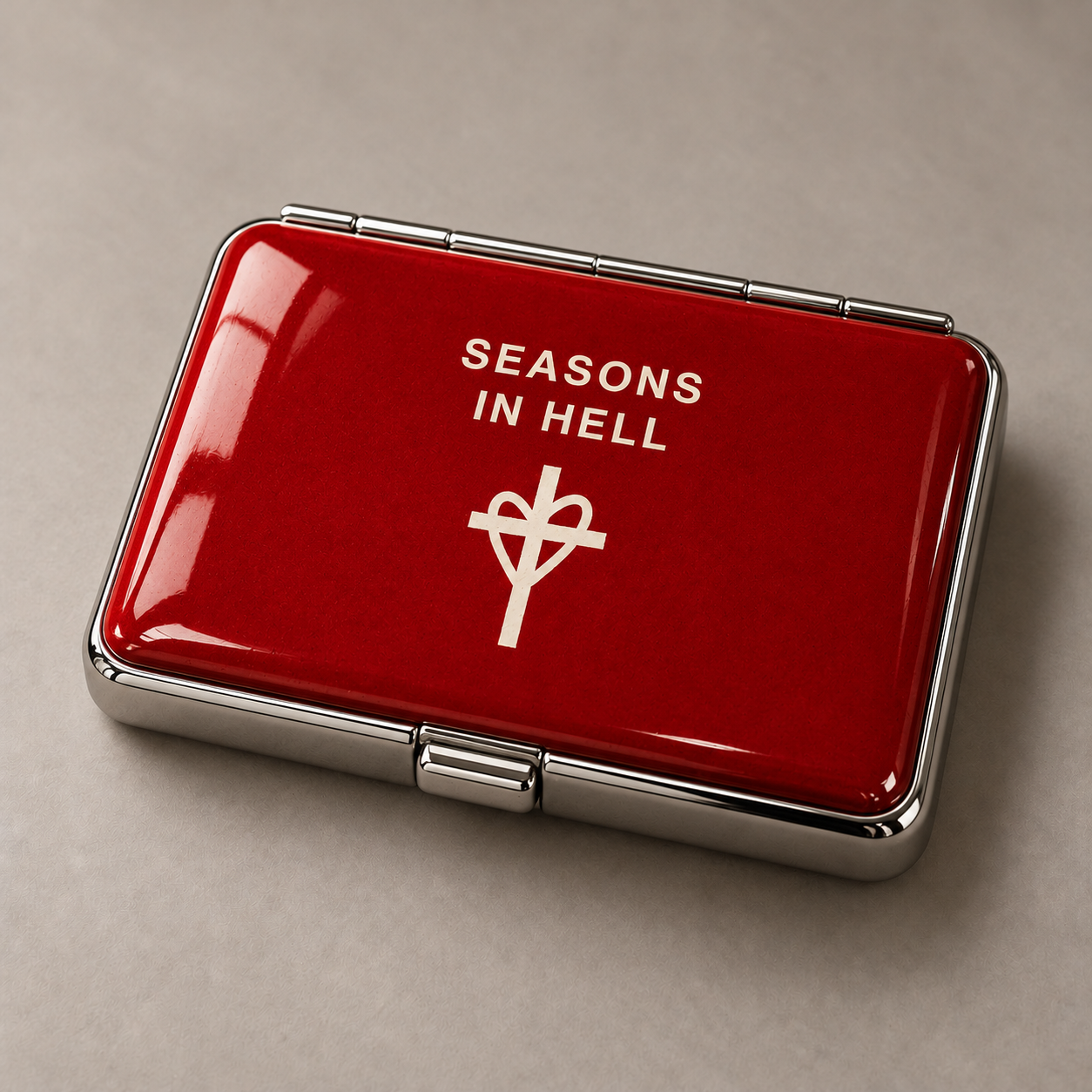 Red Cigarette Case with Seasons In Hell lettering and heart and cross